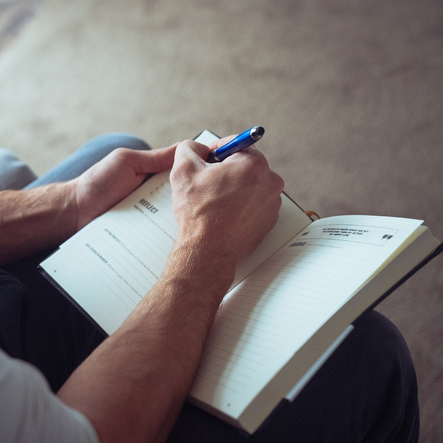 A wrestler writing in the All In journal